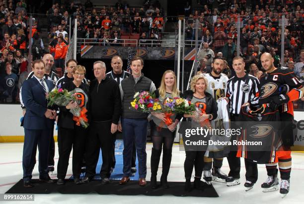 Deryk Engelland of the Vegas Golden Knights and Ryan Getzlaf of the Anaheim Ducks honor referee Dan O'Rourke , celebrating his 1000th NHL game on the...