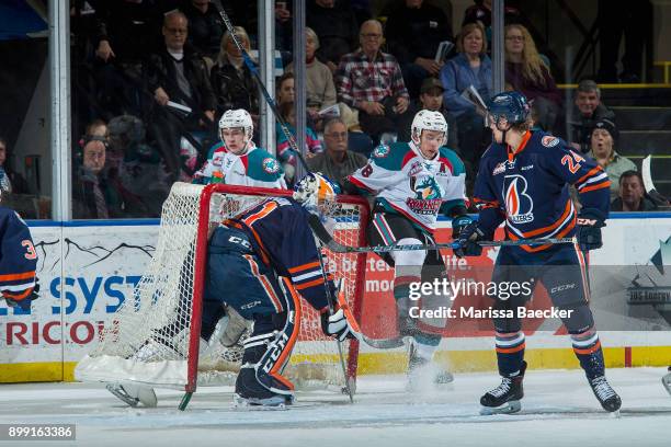 Jack Cowell of the Kelowna Rockets is checked into the net of Dylan Ferguson by Luc Smith of the Kamloops Blazers during first period action on...