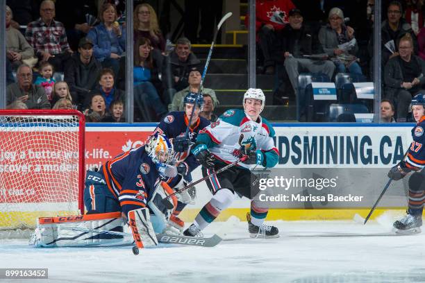 Kole Lind of the Kelowna Rockets is back checked by Joe Gatenby as Dylan Ferguson of the Kamloops Blazers makes a first period save on December 27,...