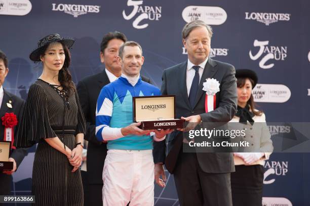 Charles Villoz presents the Longines watch to the jockey of Cheval Grand, Hugh Bowman during the Japan Cup presentation ceremony at Tokyo Racecourse...