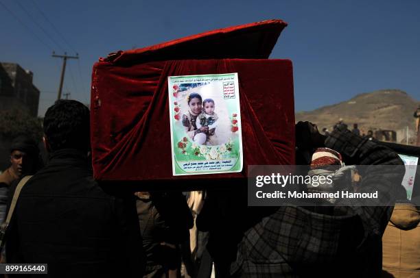 People carry coffins of 11-members from one family after they were killed by airstrikes carried out by the Saudi-led coalition hit their house on...