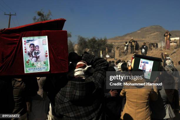 People carry coffins of 11-members from one family after they were killed by airstrikes carried out by the Saudi-led coalition hit their house on...