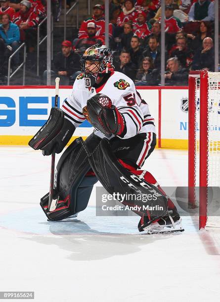 Corey Crawford of the Chicago Blackhawks defends his net against the New Jersey Devils at Prudential Center on December 23, 2017 in Newark, New...