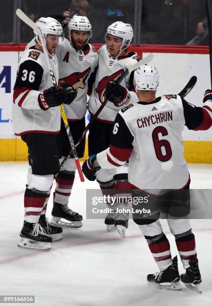 Arizona Coyotes defenseman Alex Goligoski center, celebrates his goal with right wing Christian Fischer center Clayton Keller and defenseman Jakob...