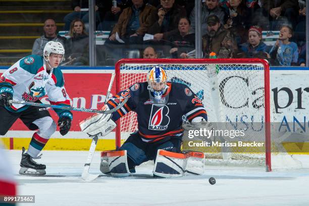 Jack Cowell of the Kelowna Rockets skates for the puck after a deflection by Dylan Ferguson of the Kamloops Blazers during second period on December...