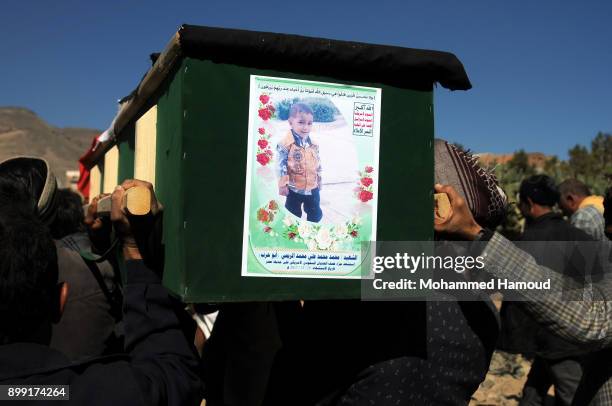 People carry coffins of 11-members from one family after they were killed by airstrikes carried out by the Saudi-led coalition hit their house on...