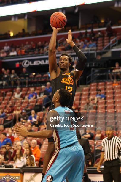 Oklahoma State Cowboys forward Cameron McGriff shoots over Florida State Seminoles guard Trent Forrest during the first half of the MetroPCS Orange...