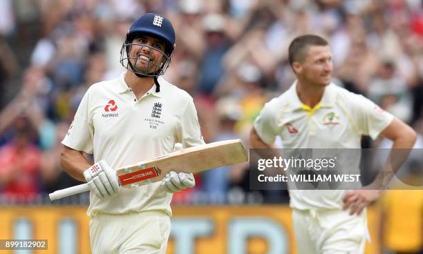 England's batsman Alastair Cook celebrates scoring his double century as Australia's Jackson Bird looks on, on the third day of the fourth Ashes...