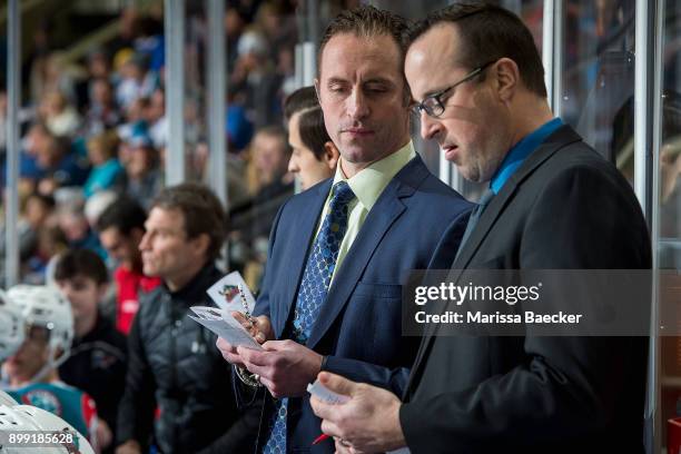 Kelowna Rockets' head coach Jason Smith stands on the bench with assistant coach Kris Mallette during an intermission before overtime against the...