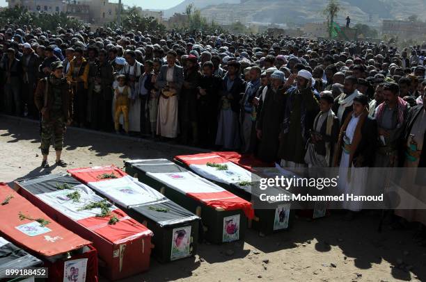 People carry coffins of 11-members from one family after they were killed by airstrikes carried out by the Saudi-led coalition hit their house on...