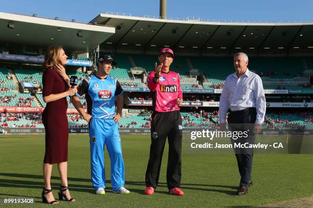 Travis Head of the Strikers and Johan Botha of the Sixers take part in the coin toss prior to the Big Bash League match between the Sydney Sixers and...