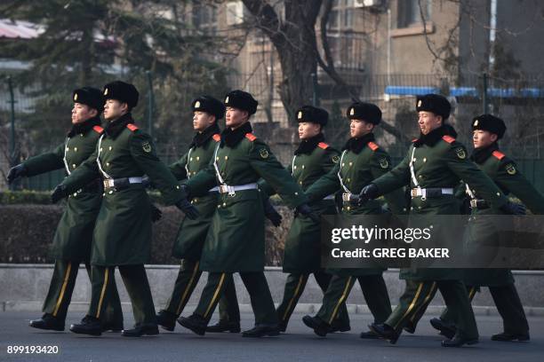 Chinese paramilitary police officers patrol in Beijing on December 28, 2017. China's paramilitary police force will soon be commanded by the Chinese...