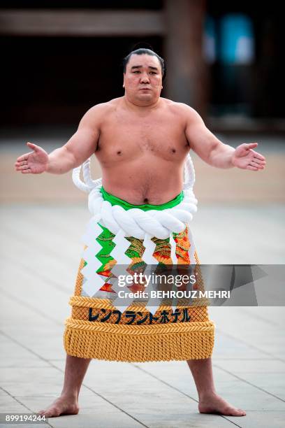 This photo taken on January 6, 2017 shows Mongolian-born sumo grand champion or "yokozuna" Harumafuji performing a ring-entering ceremony at Meiji...