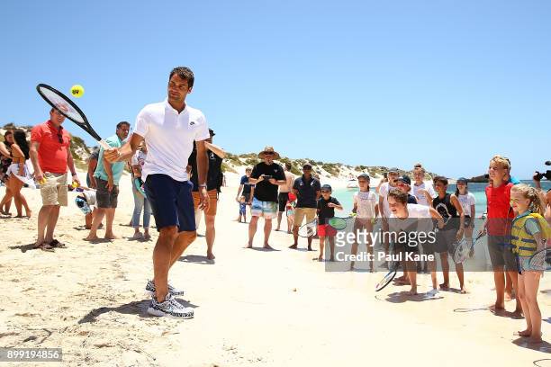 Roger Federer of Switzerland plays some tennis on the beach with children at Rottnest Island ahead of the 2018 Hopman Cup on December 28, 2017 in...