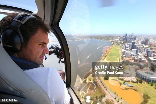 Roger Federer of Switzerland takes in the Perth CBD from a helicopter on-route to Rottnest Island ahead of the 2018 Hopman Cup on December 28, 2017...