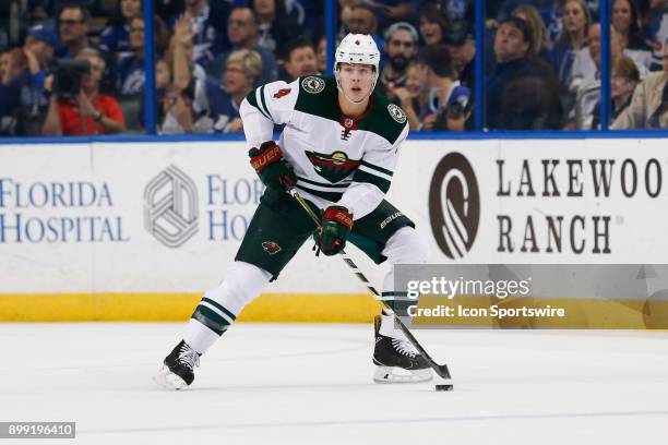 Minnesota Wild defenseman Mike Reilly skates with the puck during the NHL game between the Minnesota Wild and Tampa Bay Lightning on December 23,...