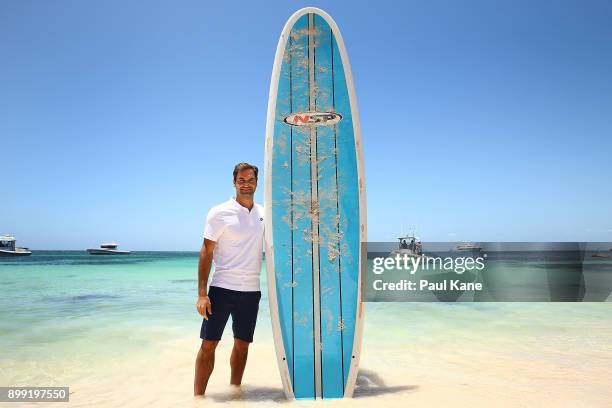 Roger Federer of Switzerland poses with a stand up paddle board at Rottnest Island ahead of the 2018 Hopman Cup on December 28, 2017 in Perth,...