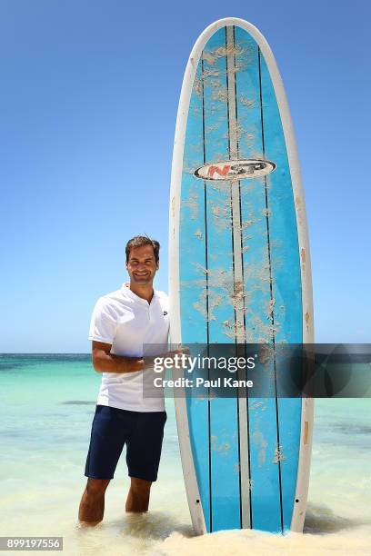 Roger Federer of Switzerland poses with a stand up paddle board at Rottnest Island ahead of the 2018 Hopman Cup on December 28, 2017 in Perth,...