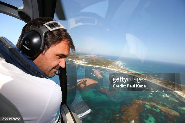 Roger Federer of Switzerland takes in the view from a helicopter on-route to Rottnest Island ahead of the 2018 Hopman Cup on December 28, 2017 in...