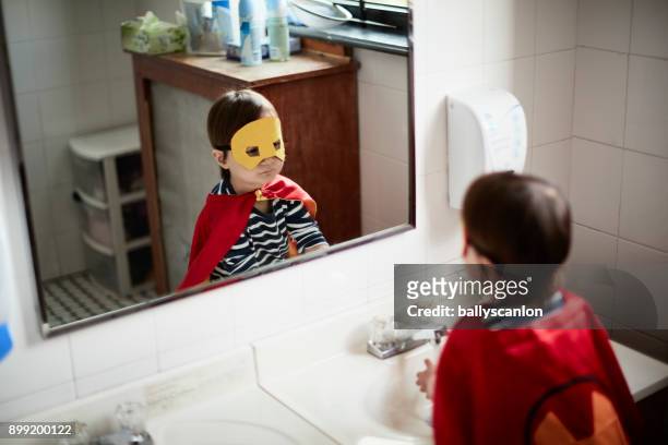 Boy Looking At Himself In A Mirror