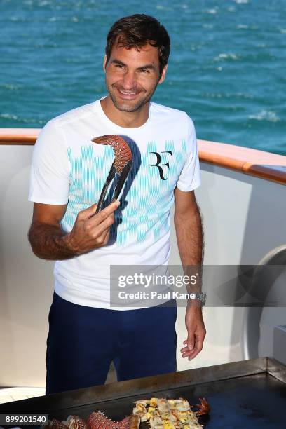 Roger Federer of Switzerland cooks a seafood BBQ lunch on board Anya at Rottnest Island ahead of the 2018 Hopman Cup on December 28, 2017 in Perth,...