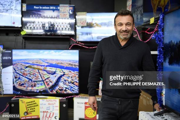 Michel Vieira, CEO of the MDA Domestic electrical goods, poses for photographs inside one of his stores on December 21, 2017 in Lozanne near Lyon,...