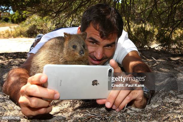 Roger Federer of Switzerland takes a selfie with a Quokka at Rottnest Island ahead of the 2018 Hopman Cup on December 28, 2017 in Perth, Australia.