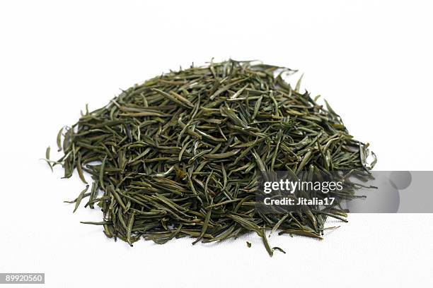 loose-leaf jasmine green tea on white background - green tea stock pictures, royalty-free photos & images