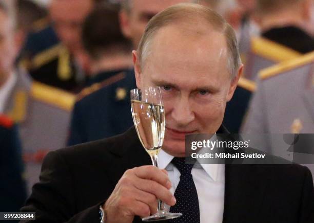 Russian President Vladimir Putin toasts during reception for military servicemen who took part in Syrian campaign, at Grand Kremlin Palace on...
