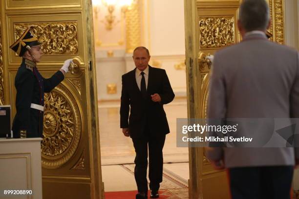 Russian President Vladimir Putin enters the hall during reception for military servicemen who took part in Syrian campaign, at Grand Kremlin Palace...