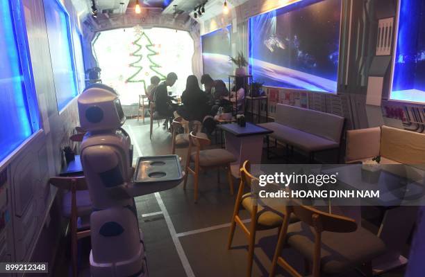 This picture taken on December 11, 2017 shows a robot named "Mortar" standing by to deliver ordered drinks to customers at the Robo Cafe, the first...