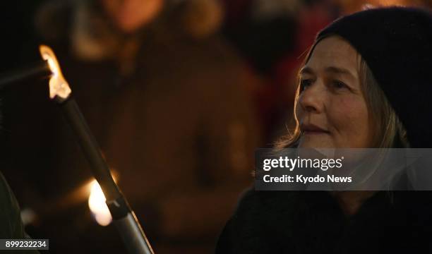 Woman holds a flaming torch during a parade held in Oslo, Norway on Dec. 10, 2017 to celebrate the awarding of the 2017 Nobel Peace Prize to the...