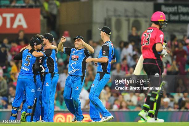 Michael Neser of the Strikers celebrates victory with team mates after taking the wicket of Stephen O'Keefe of the Sixers during the Big Bash League...