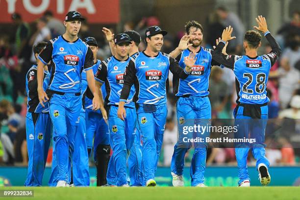 Michael Neser of the Strikers celebrates victory with team mates after taking the wicket of Stephen O'Keefe of the Sixers during the Big Bash League...