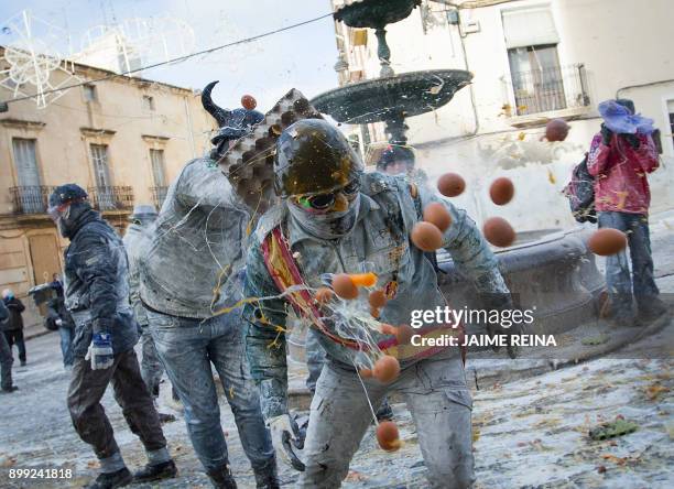 Revellers dressed in mock military garb take part in the "Els Enfarinats" battle in the southeastern Spanish town of Ibi on December 28, 2017. During...