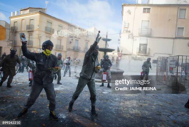 Revellers dressed in mock military garb take part in the "Els Enfarinats" battle in the southeastern Spanish town of Ibi on December 28, 2017. During...