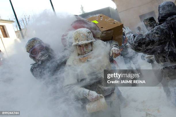 Revellers dressed in mock military garb take part in the "Els Enfarinats" battle in the southeastern Spanish town of Ibi on December 28, 2017. During...