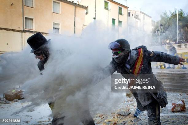 Revellers dressed in mock military garb take part in the "Els Enfarinats" battle in the southeastern Spanish town of Ibi on December 28, 2017. -...