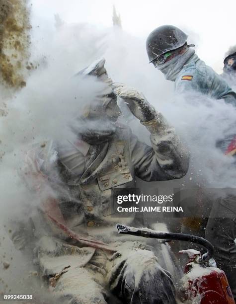 Revellers dressed in mock military garb take part in the "Els Enfarinats" battle in the southeastern Spanish town of Ibi on December 28, 2017. During...