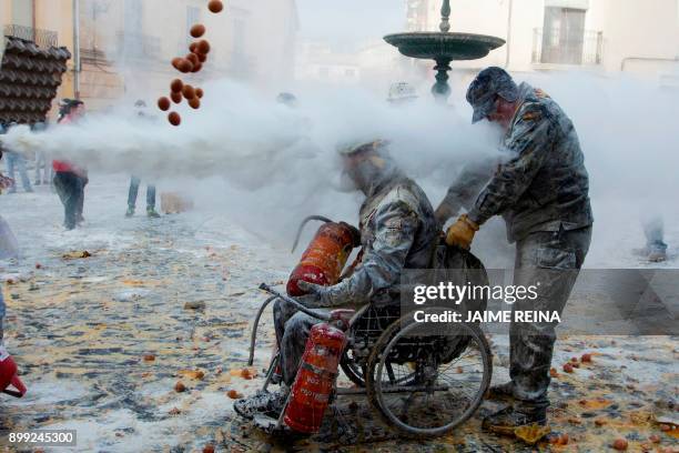 Revellers dressed in mock military garb take part in the "Els Enfarinats" battle in the southeastern Spanish town of Ibi on December 28, 2017. During...