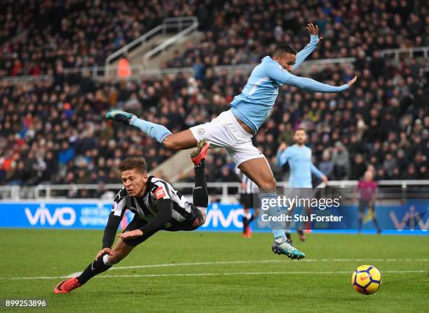 Dwight Gayle of Newcastle United goes to ground after a challenge with Danilo of Manchester City but is later booked for diving during the Premier...