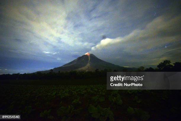 Sinabung Mountain scatters volcanic material and hot lava from its crater as seen from Tiga kicat, North Sumatra, Indonesia, on Thursday, December...