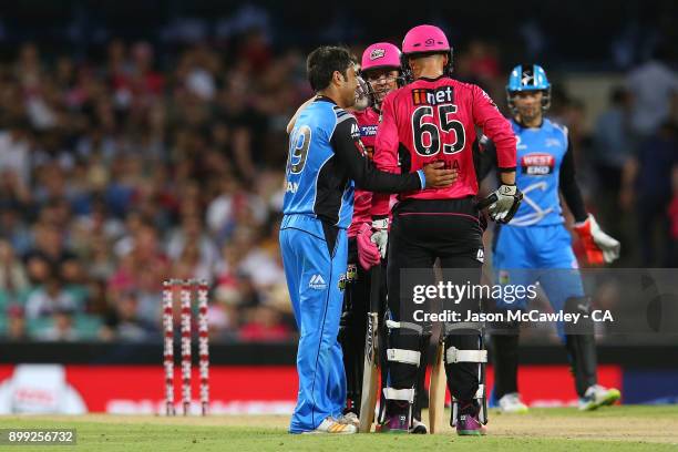 Rashid Khan of the Strikers talks to Johan Botha of the Sixers during the Big Bash League match between the Sydney Sixers and the Adelaide Strikers...