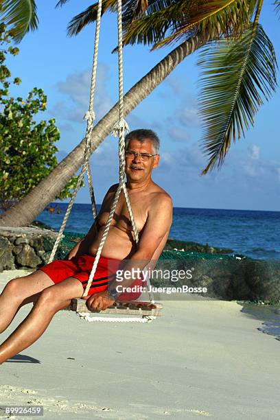 retiree having fun on the maldives - juergen bosse stockfoto's en -beelden