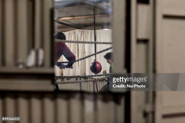 In a mirror the image of young boxers training is reflected in Osorno, Chile on 27 December 2017. At the heart of the Eleuterio Ramírez town of...