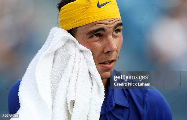Rafael Nadal of Spain wipes sweat from his face against Andreas Seppi of Italy during day three of the Western & Southern Financial Group Masters on...