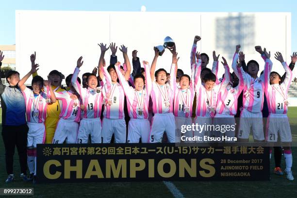 Players of Sagan Tosu U-15 celebrate their victory as captain Hikaru Suetsugi lifts the trophy after the Prince Takamado Cup 29th All Japan Youth...