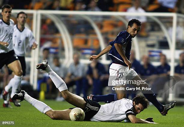 Christoph Metzelder of Germany falls under the challenge from Landon Donovan of the USA during the FIFA World Cup Finals 2002 Quarter-Finals match...