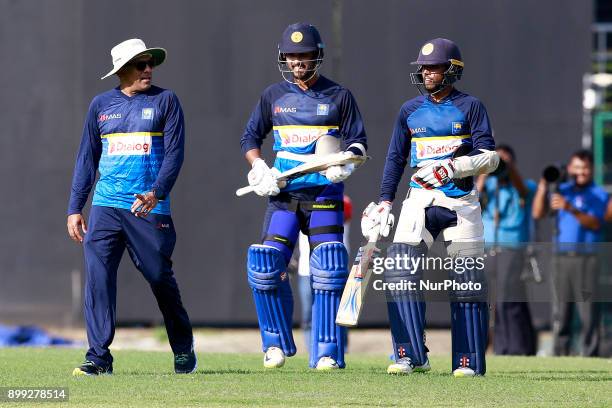 Sri Lanka cricket's new head coach Chandika Hathurusingha, Dinesh Chandimal and Kusal Mendis are seen during a practice session with the Sri Lankan...