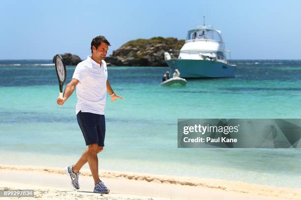 Roger Federer of Switzerland walks along the beach after arriving at Rottnest Island ahead of the 2018 Hopman Cup on December 28, 2017 in Perth,...